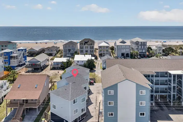 Aerial close-up of the building with the ocean behind it