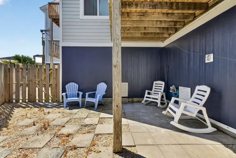 Fenced courtyard with Adirondack chairs