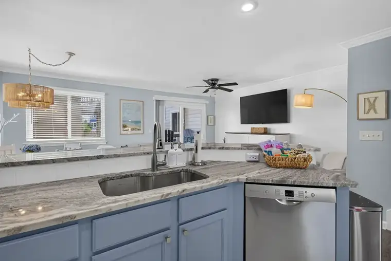 Kitchen breakfast bar opening onto the living room